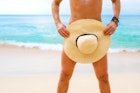 Close-up photo of man covering himself with summer hat
